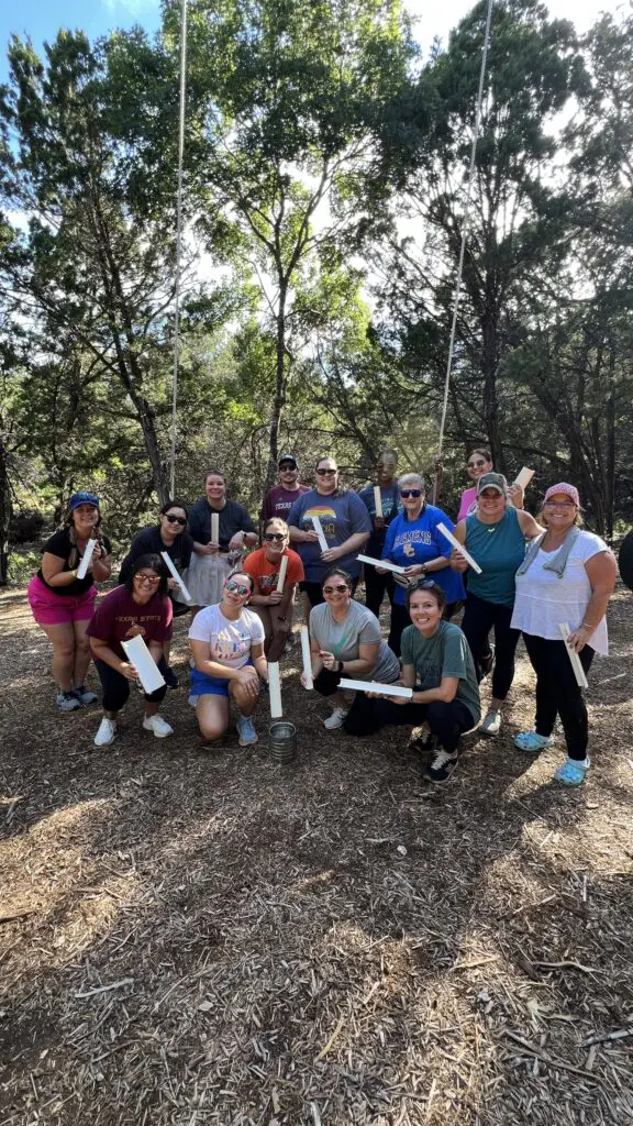 Corporate team reflecting after team building at CVTC San Antonio ropes course.