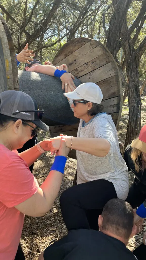 Group working together on a ground-based team challenge at CVTC.